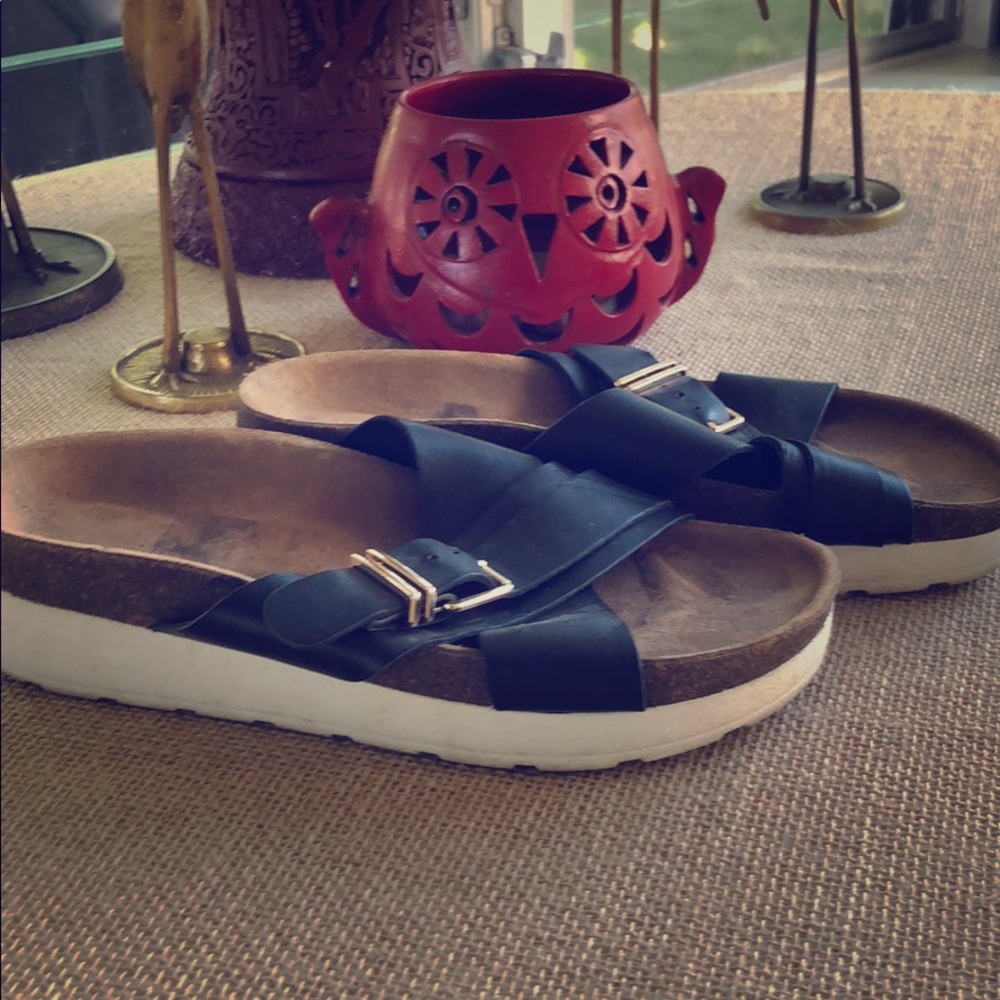 Black leather Aldo slides.